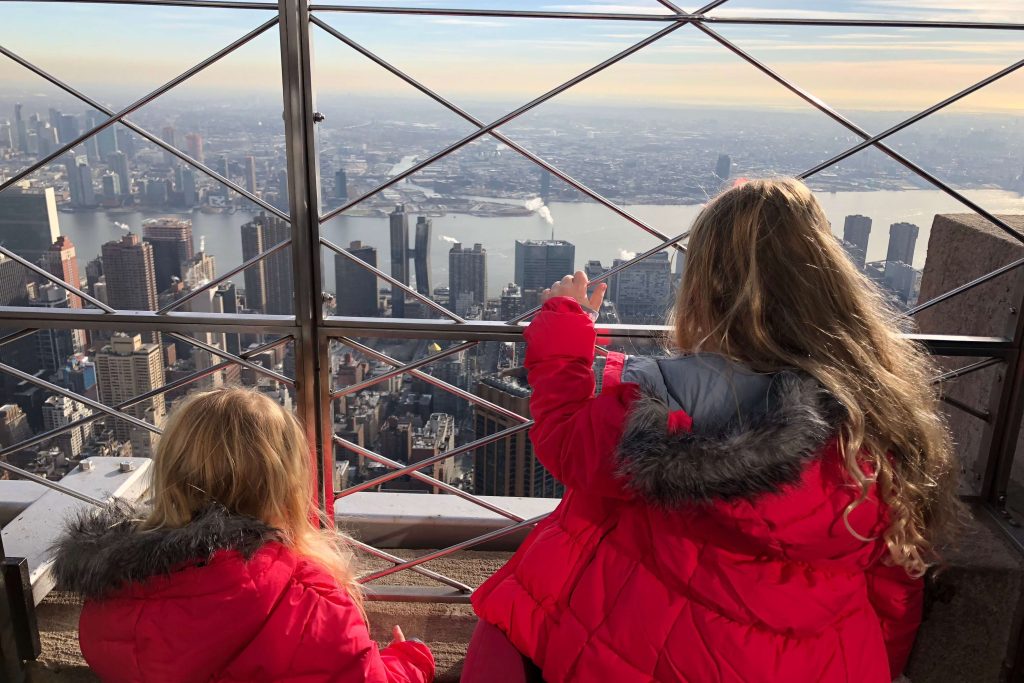 Two children on top of the empire state building, just one of the Things to do in New York with kids