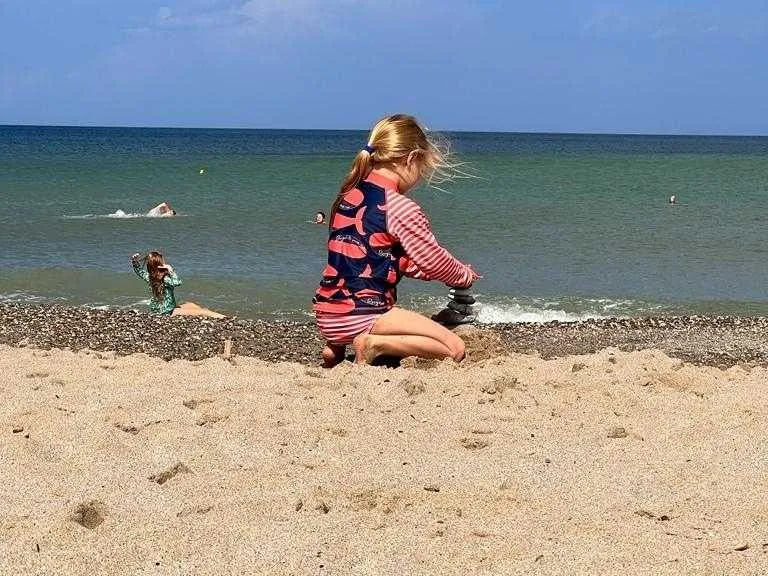 Girl playing on the beach, Crete, Greece